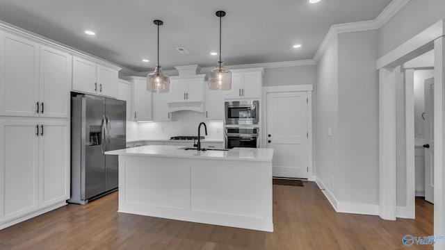 130 Iberville St, Madison, AL 35758 - kitchen featuring appliances with stainless steel finishes, ornamental molding, white cabinets, light countertops, and dark wood-style flooring