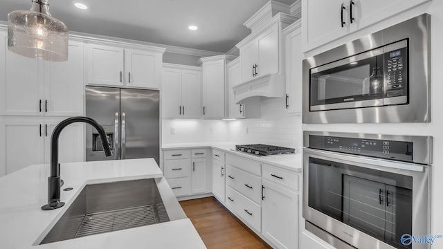 130 Iberville St, Madison, AL 35758 - kitchen featuring appliances with stainless steel finishes, light countertops, white cabinetry, recessed lighting, and decorative light fixtures