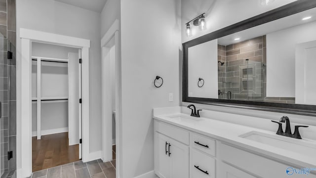 130 Iberville St, Madison, AL 35758 - bathroom featuring a stall shower, double vanity, and a spacious closet