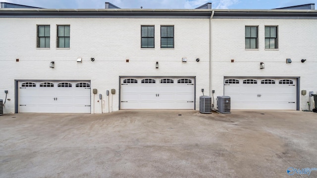 130 Iberville St, Madison, AL 35758 - back of property featuring brick siding, a garage, and driveway