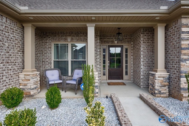 view of exterior entry featuring covered porch