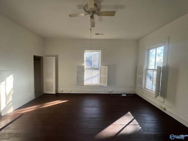 unfurnished dining area featuring ceiling fan and dark wood-type flooring