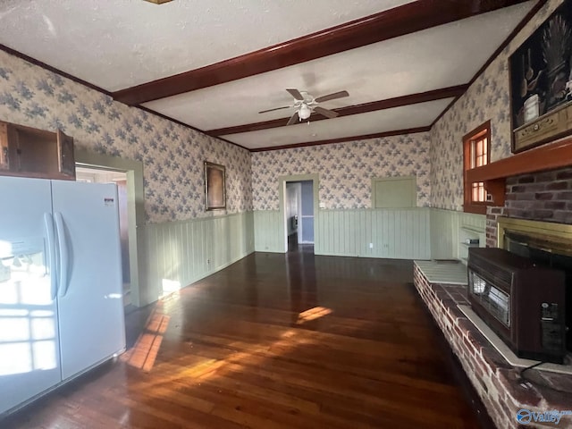 kitchen with white refrigerator, ceiling fan, ornamental molding, beamed ceiling, and wood-type flooring