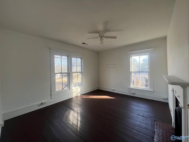 unfurnished living room featuring ceiling fan and dark hardwood / wood-style flooring