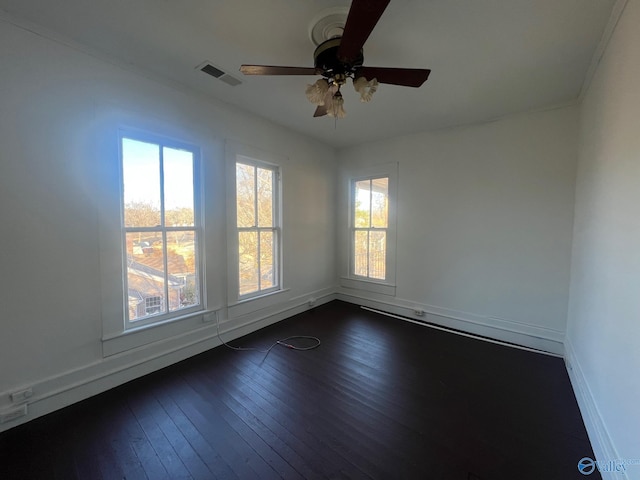 empty room featuring dark hardwood / wood-style flooring and ceiling fan