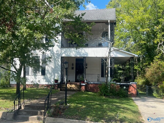 view of front of house with a porch and a front lawn