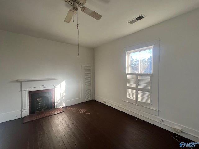 unfurnished living room featuring dark hardwood / wood-style flooring and ceiling fan