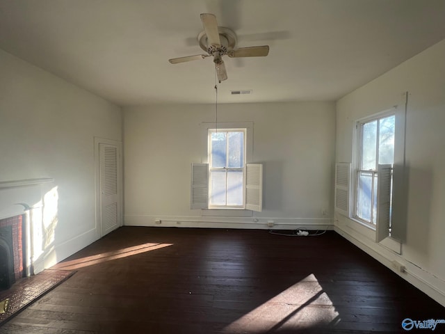 unfurnished dining area featuring ceiling fan and dark wood-type flooring