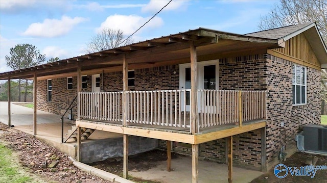 view of property exterior with a patio area, central air condition unit, and a deck