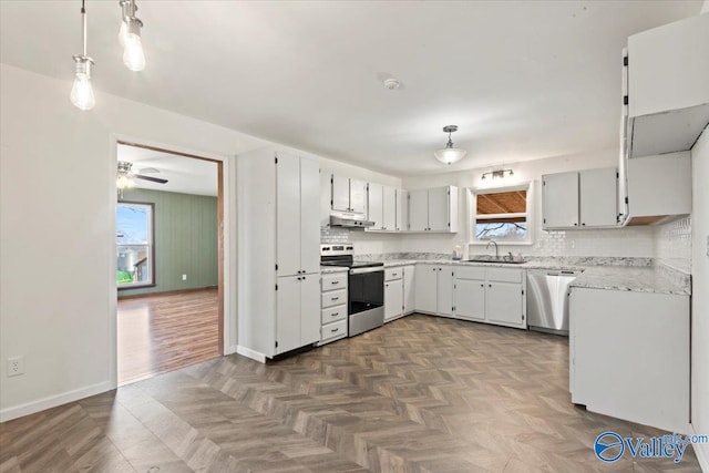 kitchen with tasteful backsplash, stainless steel appliances, sink, and hanging light fixtures