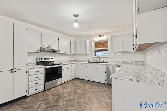 kitchen featuring dark parquet flooring, appliances with stainless steel finishes, sink, and white cabinets