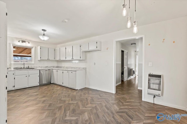 kitchen with sink, dishwasher, hanging light fixtures, heating unit, and white cabinets