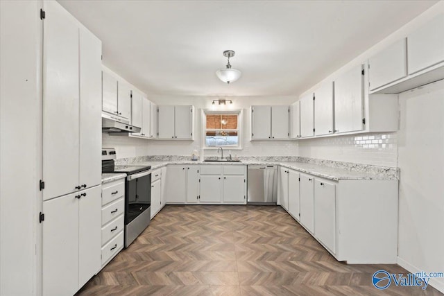 kitchen with stainless steel appliances, dark parquet floors, and white cabinets