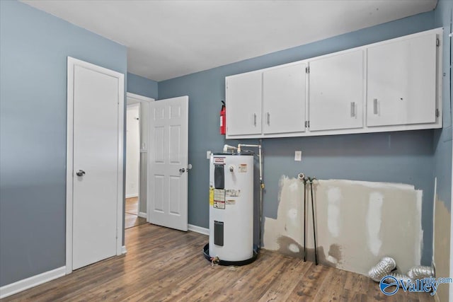 washroom with cabinets, dark hardwood / wood-style flooring, and electric water heater