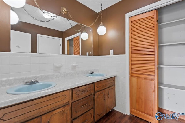 bathroom with vanity, hardwood / wood-style flooring, and tile walls