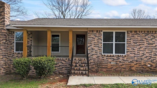 view of exterior entry with covered porch