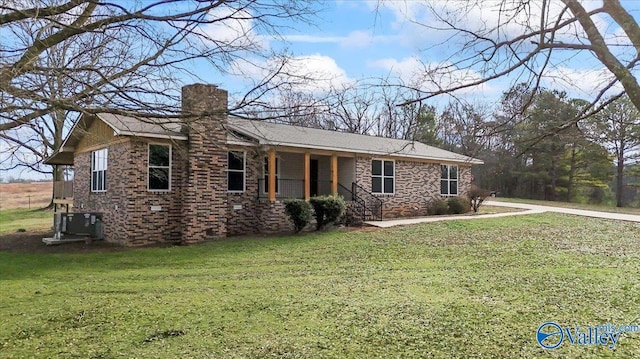 ranch-style house with central AC unit and a front yard