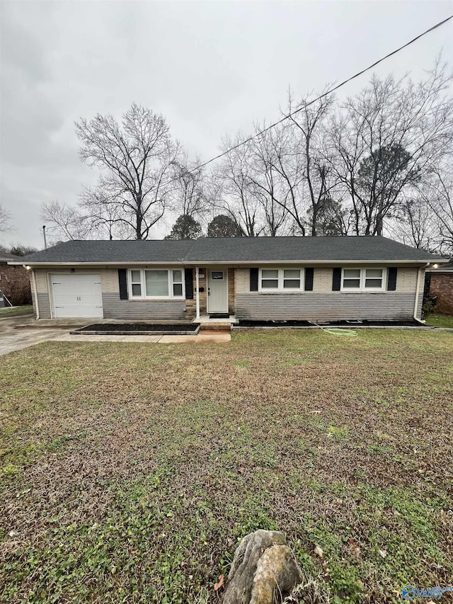 ranch-style home with a garage and a front lawn