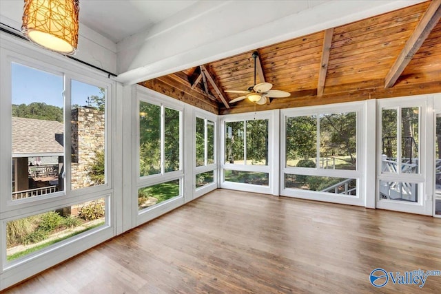 unfurnished sunroom featuring lofted ceiling with beams and a wealth of natural light