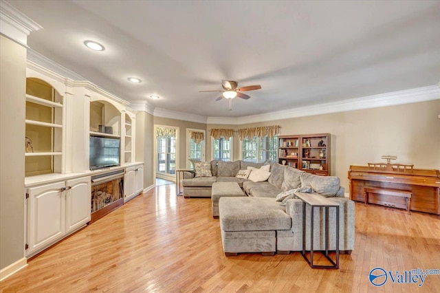 living room featuring crown molding, ceiling fan, and light hardwood / wood-style flooring