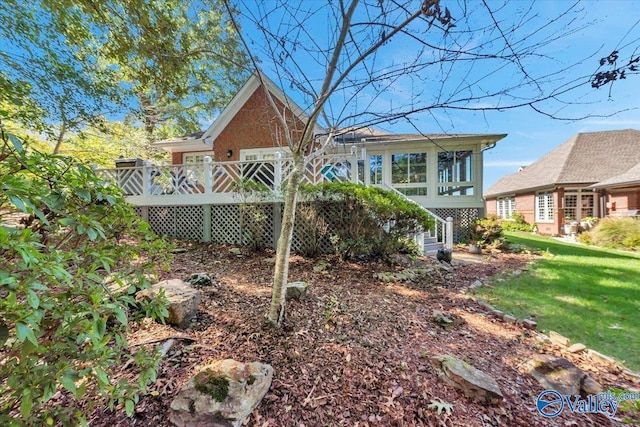 exterior space featuring a deck and a lawn