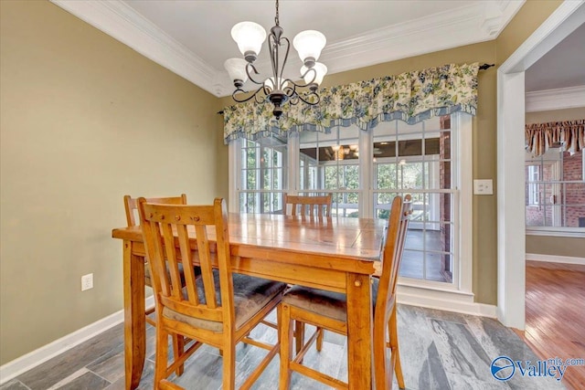 dining space featuring hardwood / wood-style flooring, a notable chandelier, plenty of natural light, and crown molding