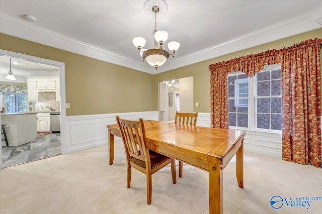 dining room featuring light carpet, crown molding, and a chandelier