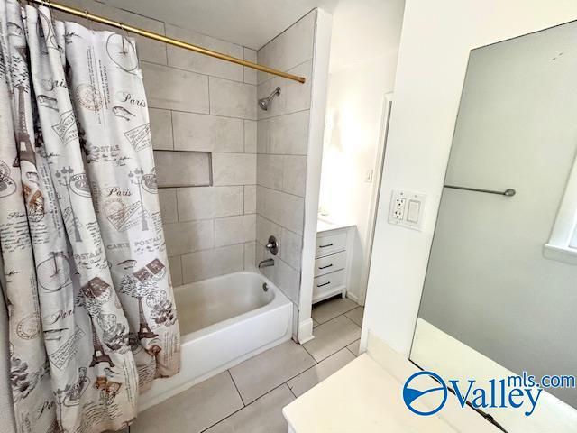 full bathroom featuring tile patterned floors and shower / bath combo