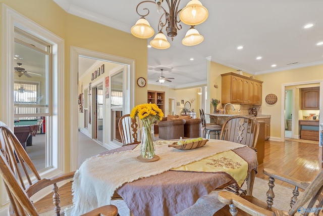 dining room with light wood-style flooring, recessed lighting, and ornamental molding