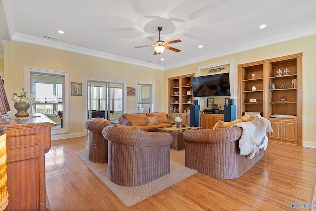 living room featuring baseboards, light wood-style floors, ceiling fan, and crown molding