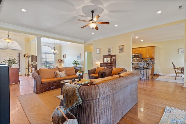 living area with visible vents, light wood-style flooring, crown molding, and decorative columns