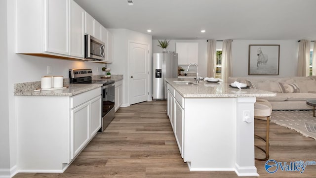 18876 Wicklow Cir, Athens, AL 35613 - kitchen with a kitchen island with sink, sink, stainless steel appliances, and white cabinets