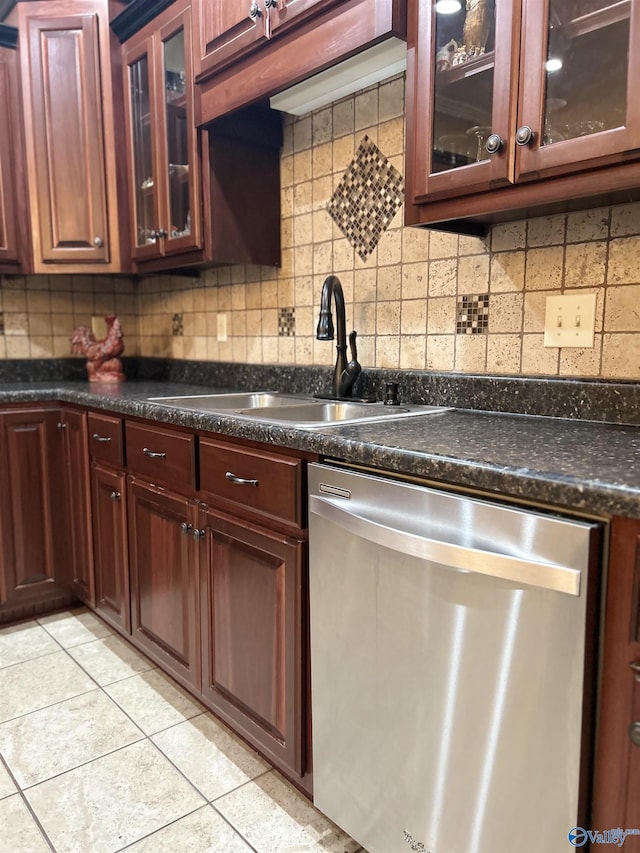 kitchen with light tile patterned floors, dishwasher, sink, and backsplash