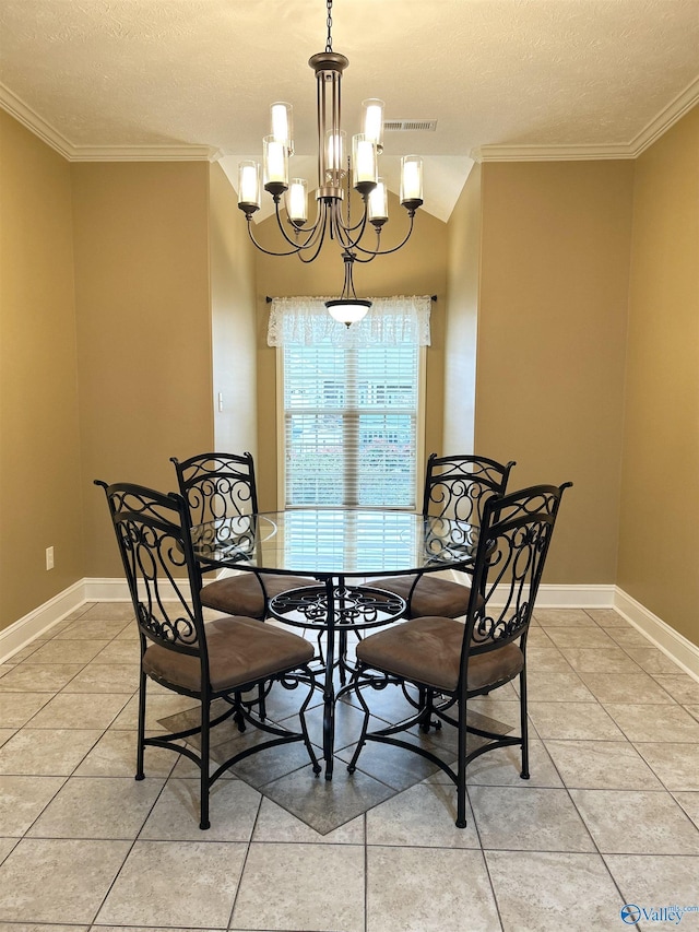 tiled dining room with an inviting chandelier, ornamental molding, and a textured ceiling