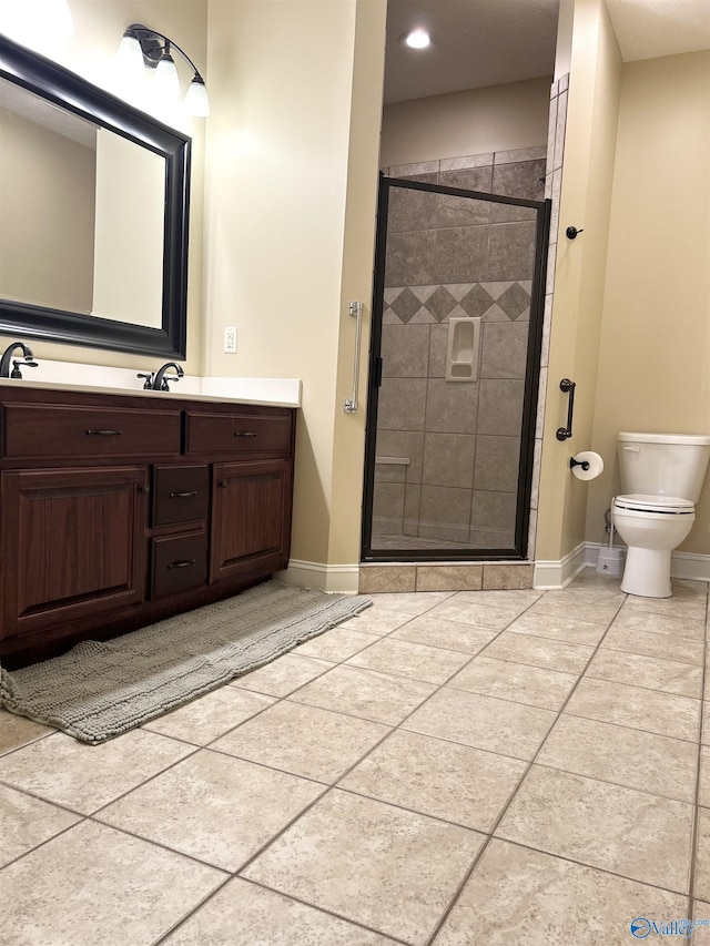 bathroom featuring vanity, an enclosed shower, tile patterned floors, and toilet