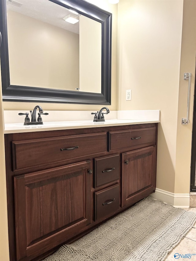 bathroom with tile patterned flooring and vanity