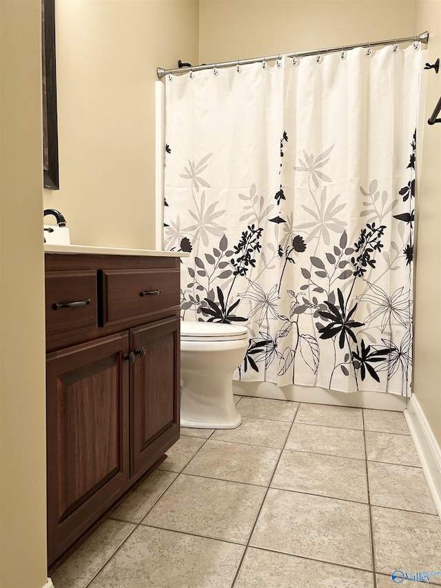 bathroom with tile patterned flooring and toilet