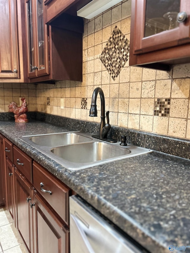 kitchen with light tile patterned floors, dishwasher, sink, and backsplash