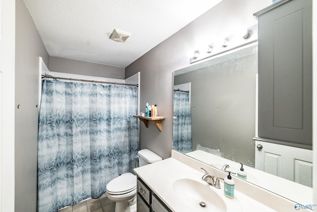 bathroom with vanity, tile patterned floors, a textured ceiling, and toilet