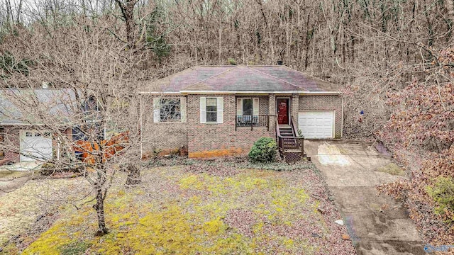 single story home featuring a porch and a garage