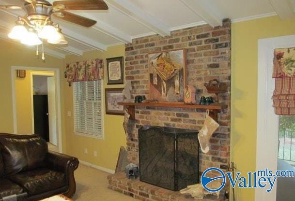 living room featuring ceiling fan, ornamental molding, lofted ceiling with beams, and a brick fireplace