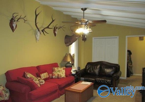 living room with beamed ceiling and ceiling fan