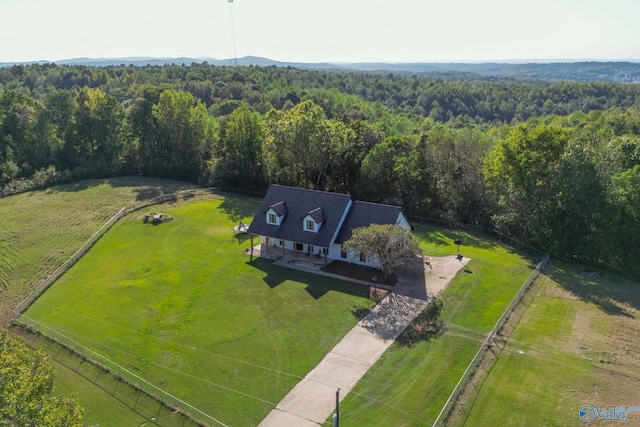 drone / aerial view featuring a rural view and a view of trees