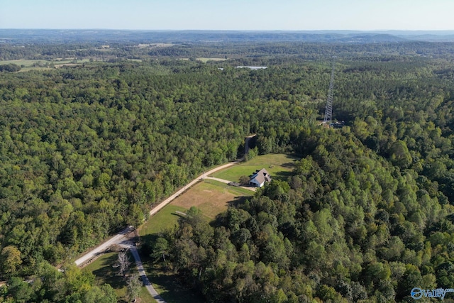 drone / aerial view featuring a wooded view