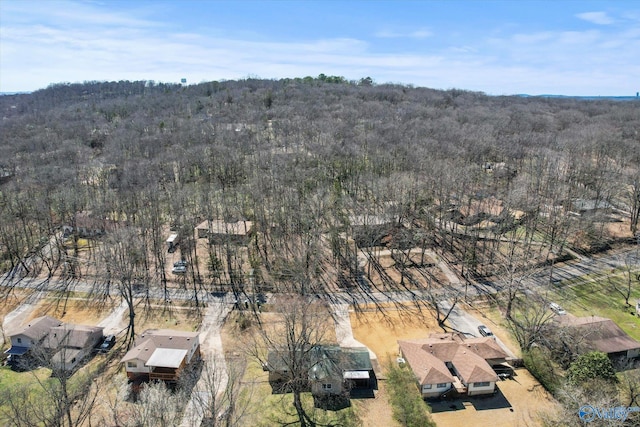 birds eye view of property featuring a wooded view