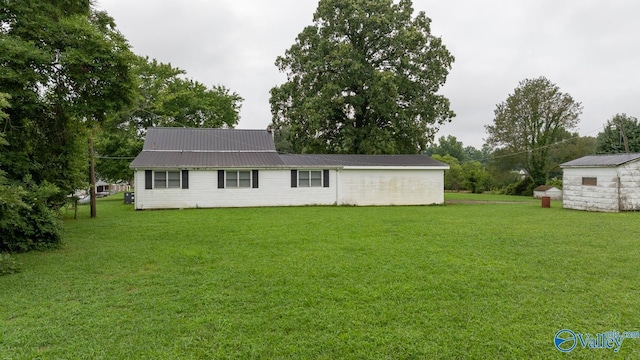 exterior space with a storage shed and a lawn