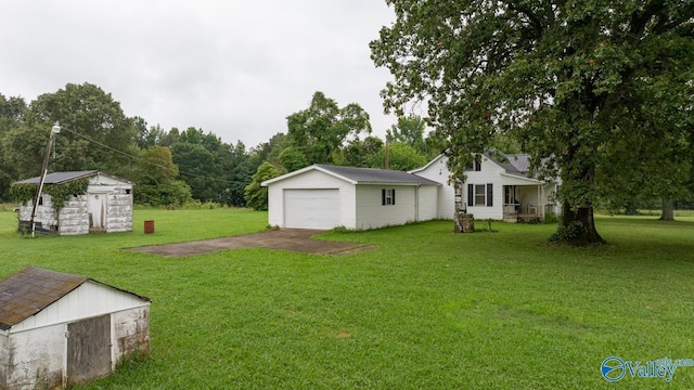 view of yard featuring a storage shed and a garage