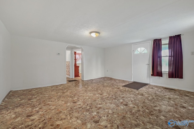 empty room with a textured ceiling