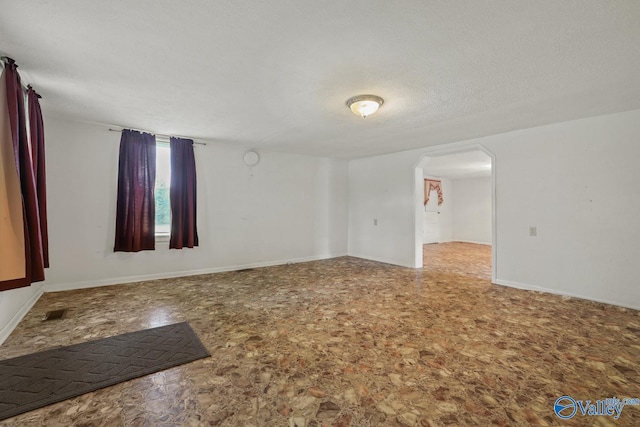 spare room with a textured ceiling