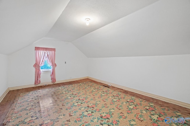 bonus room featuring lofted ceiling and wood-type flooring